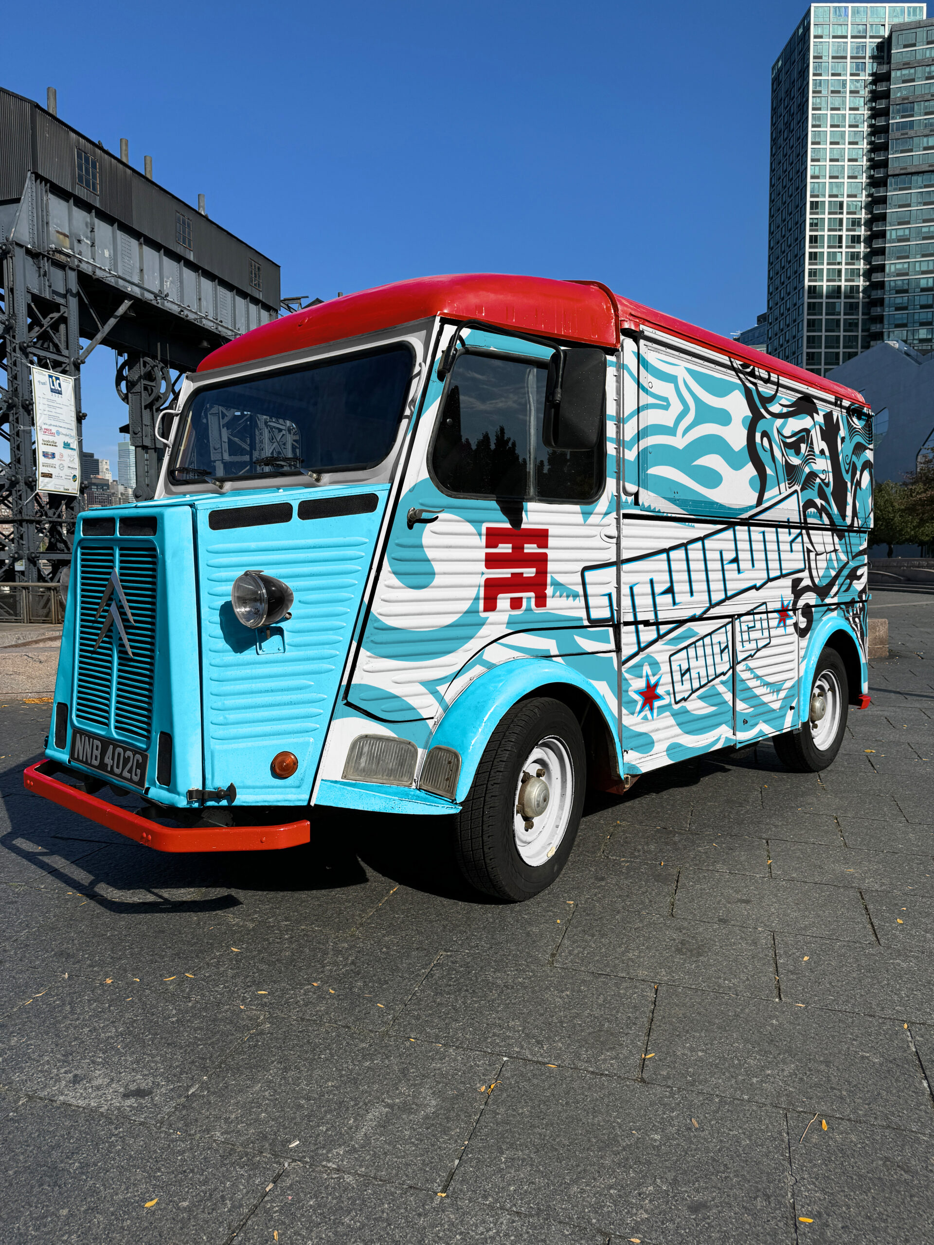 Front three-quarter view of a custom Chicago-themed Citroën food truck with promotional vehicle wrap.