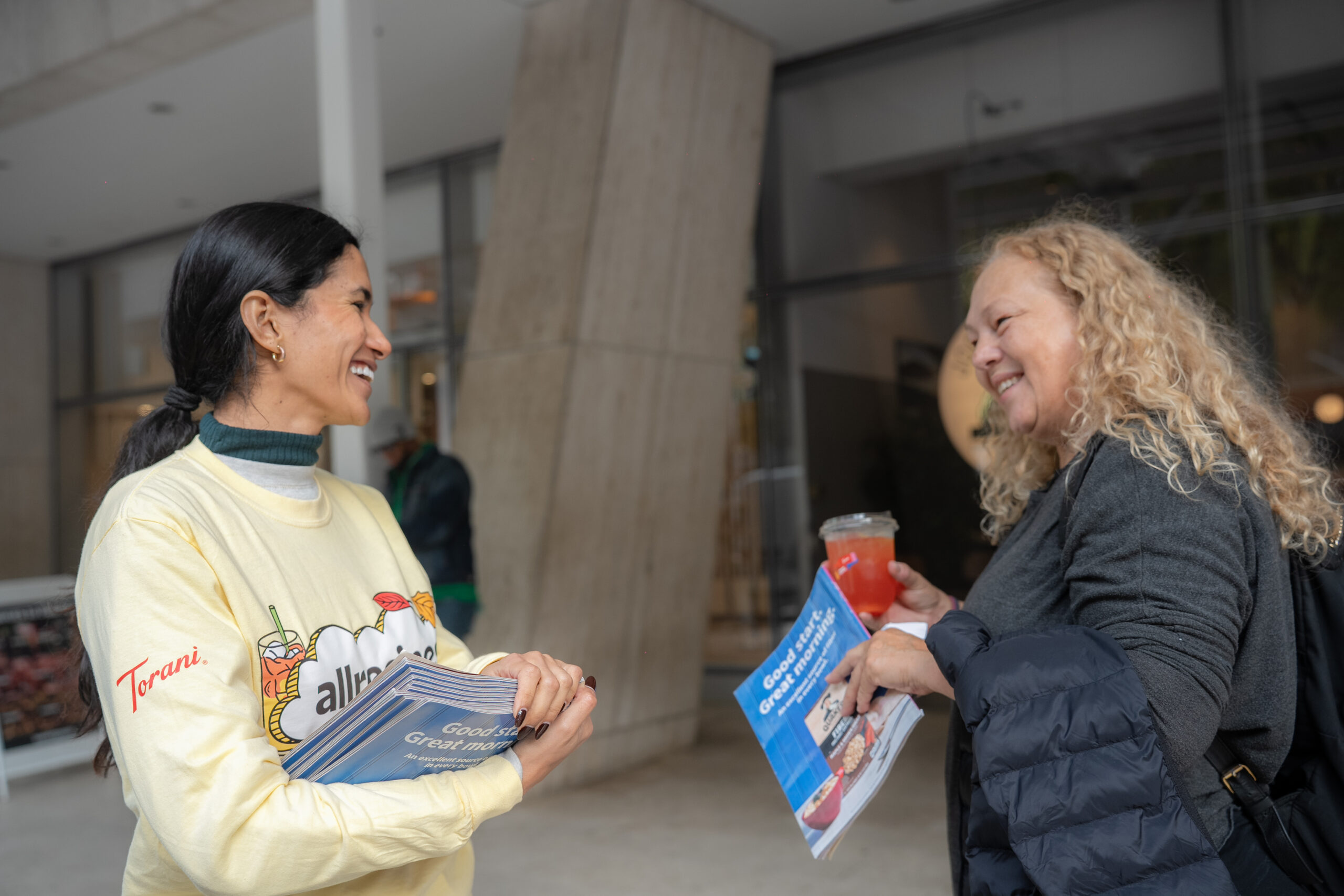 Allrecipes brand ambassador speaking with a guest during the sampling activation.
