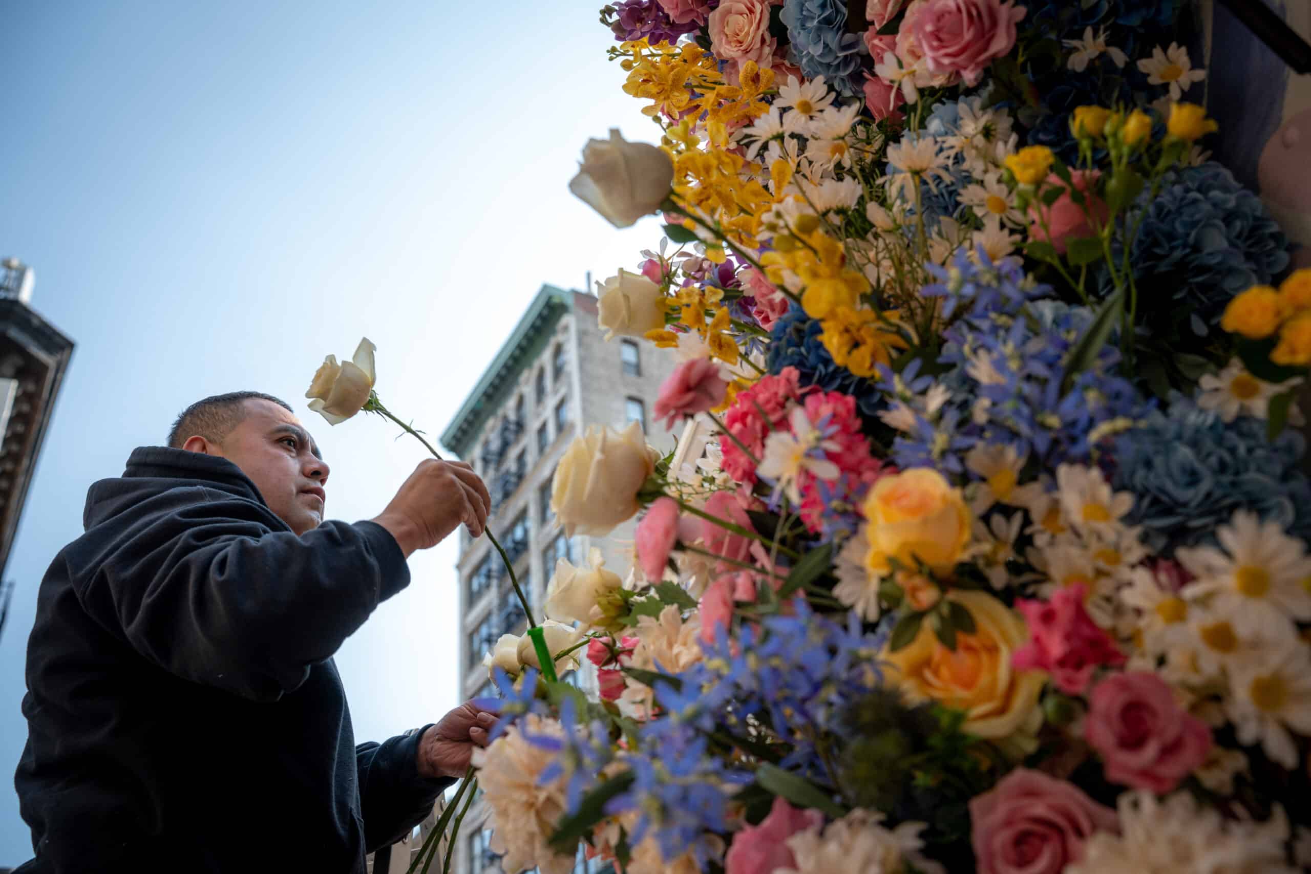 Close-up of a colorful flower wall being assembled for the Gillette Venus activation.